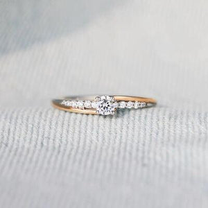 a close up of a diamond ring on a cloth