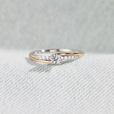 a close up of a diamond ring on a white cloth