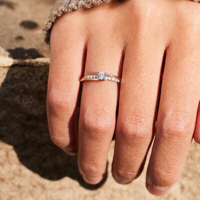 a woman's hand with a diamond ring on it