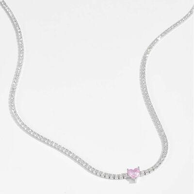 a white necklace with a pink heart on it