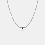 a necklace with a heart shaped green stone