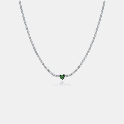 a necklace with a heart shaped green stone