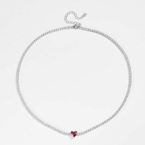 a white bracelet with a red heart on it