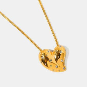 a heart shaped pendant with diamonds on a chain