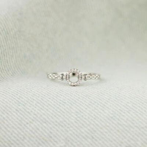 a close up of a ring on a white cloth