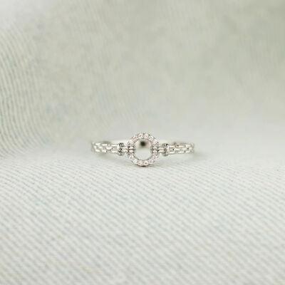 a close up of a ring on a white cloth