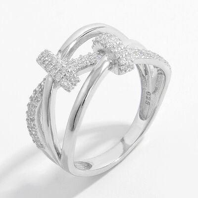 a white gold ring with a cross on it