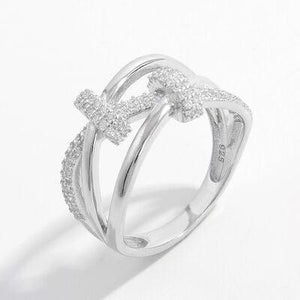 a diamond cross ring on a white background