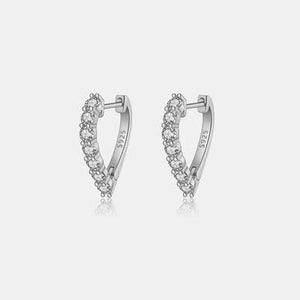 a pair of silver earrings with crystal stones