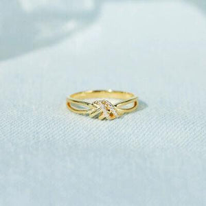 a close up of a gold ring on a white surface