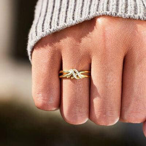 a close up of a person's hand with a ring on it