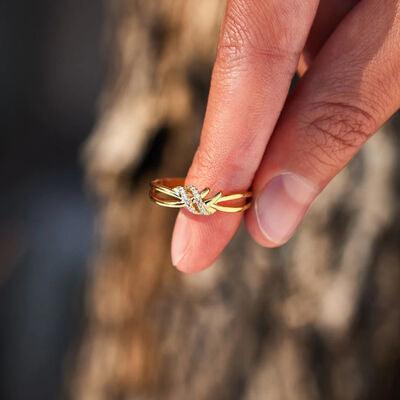 a woman's hand holding a ring with a flower on it