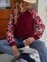 a woman sitting on a table wearing a hat and jeans