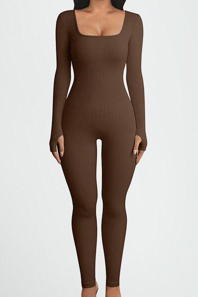 a woman wearing a brown bodysuit and high heels