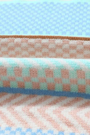 a close up of a blanket on a bed