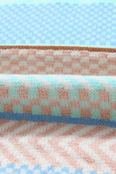 a close up of a blanket on a bed