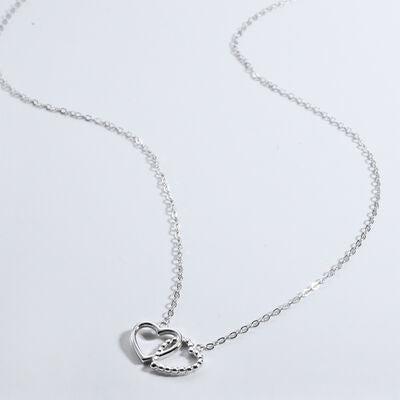 a silver necklace with a heart on it