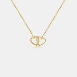 a gold necklace with two intertwined hearts