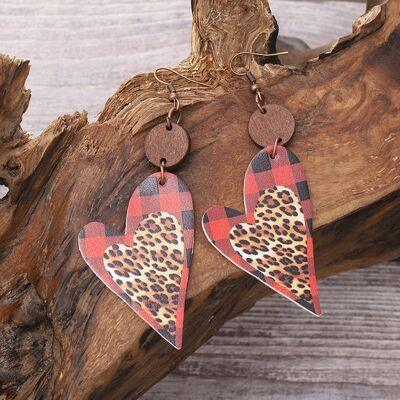 a pair of leopard print heart shaped earrings
