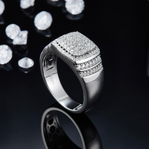 a ring with diamonds on a black surface