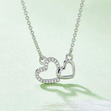 a heart shaped necklace with diamonds on a chain