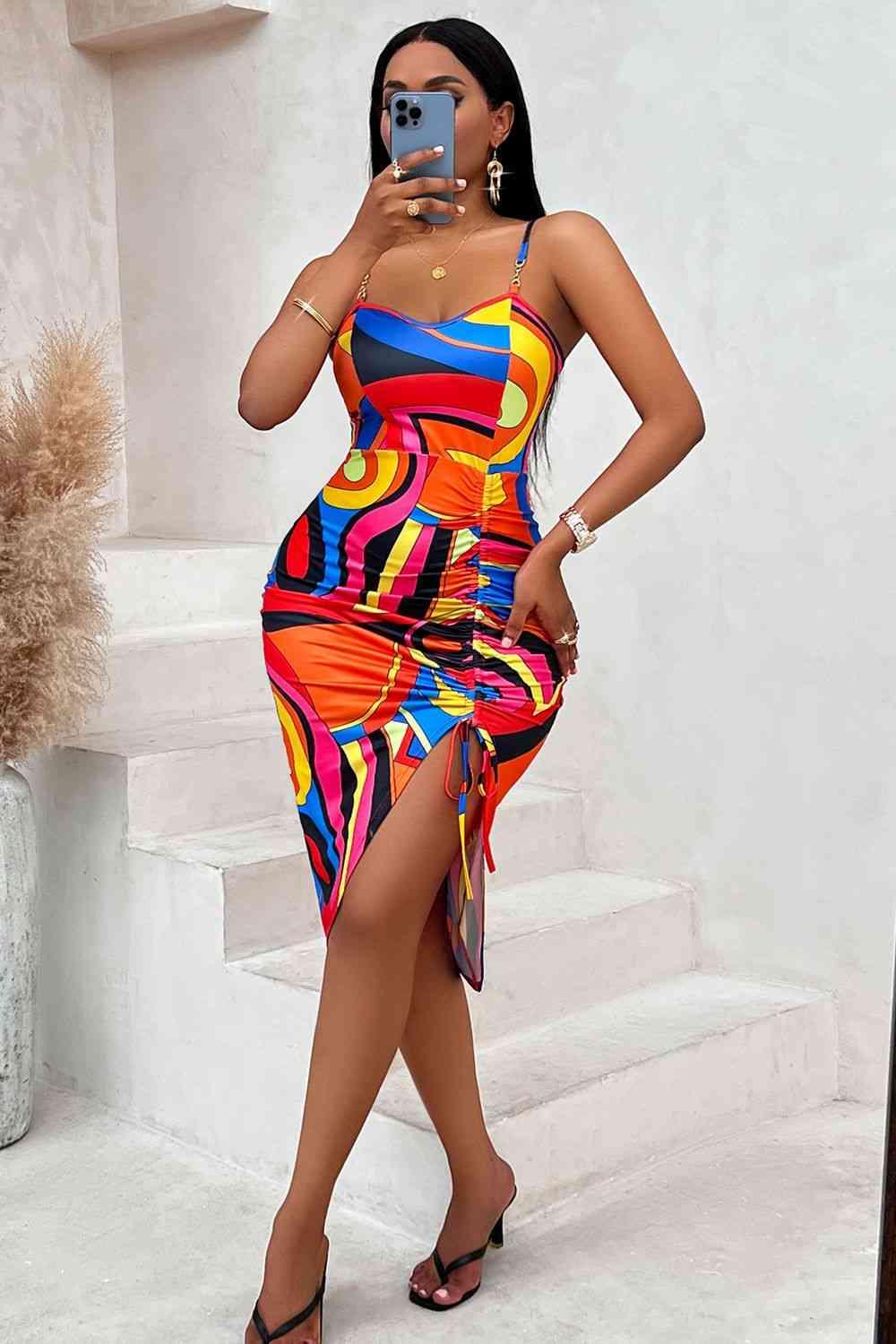 a woman taking a picture of herself in a colorful dress