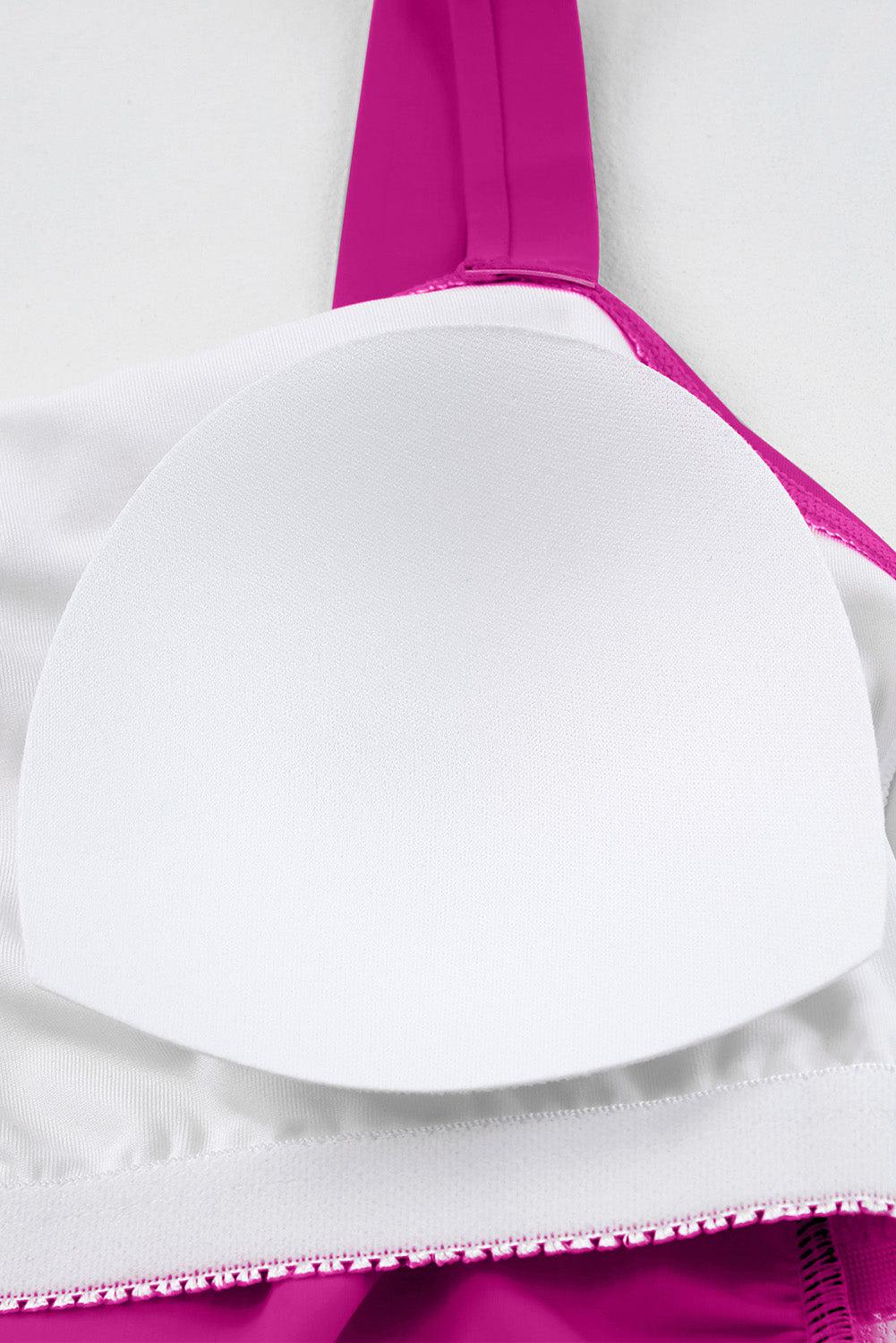 a close up of a pink and white bra