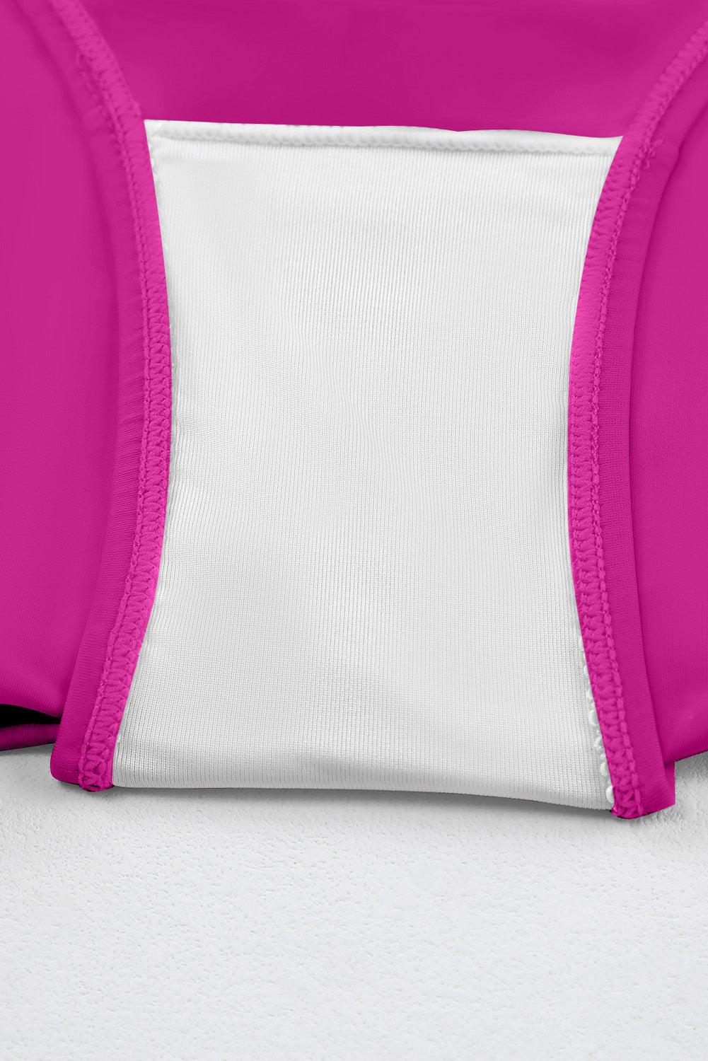 a close up of a pink and white backpack