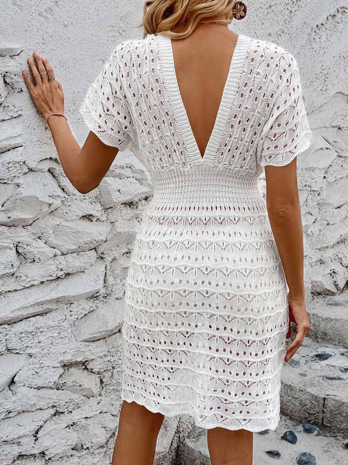 a woman wearing a white crochet dress