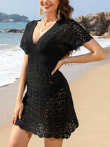 a beautiful woman standing on top of a sandy beach