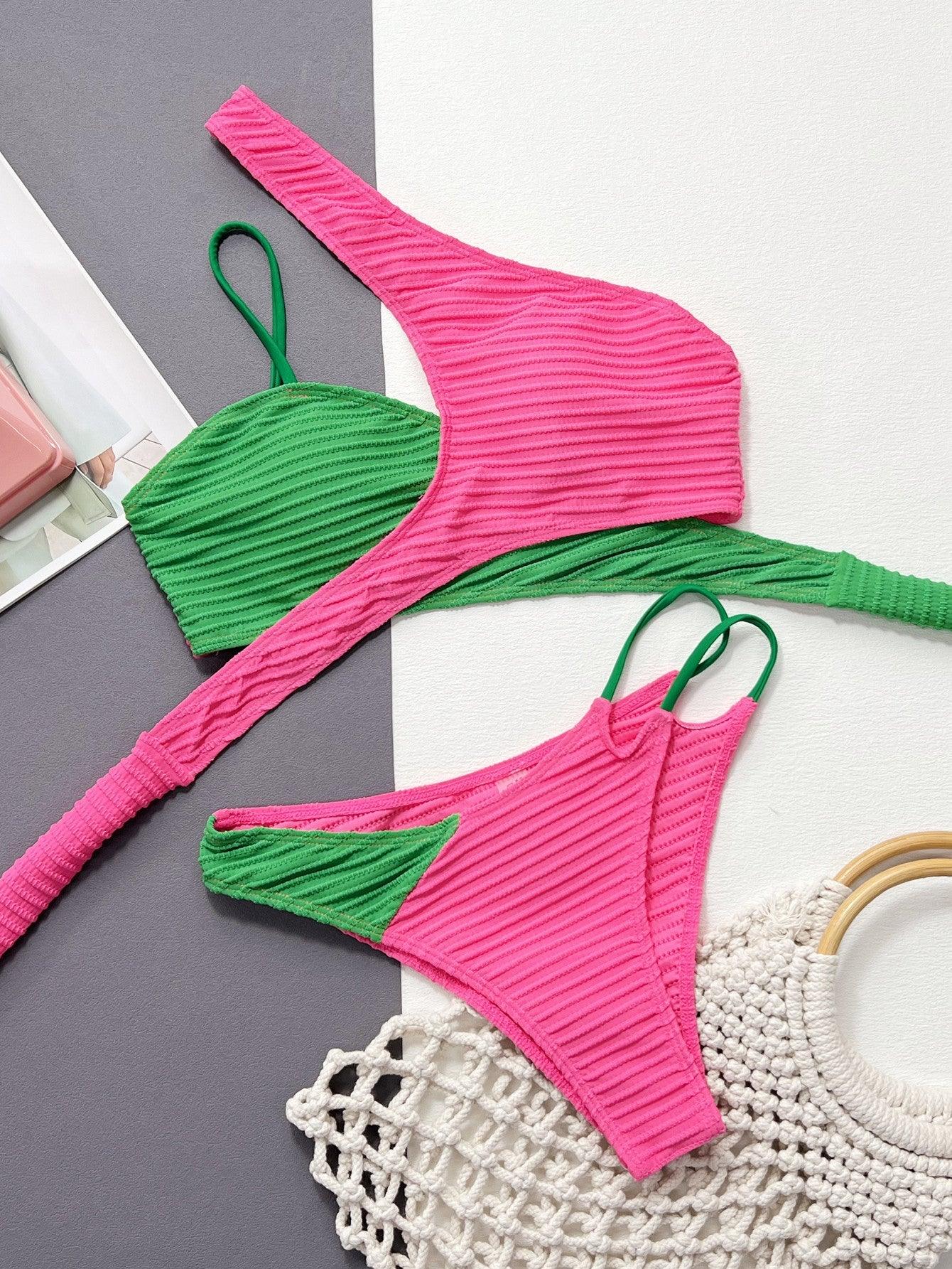 two pieces of pink and green bikinisuit on a table