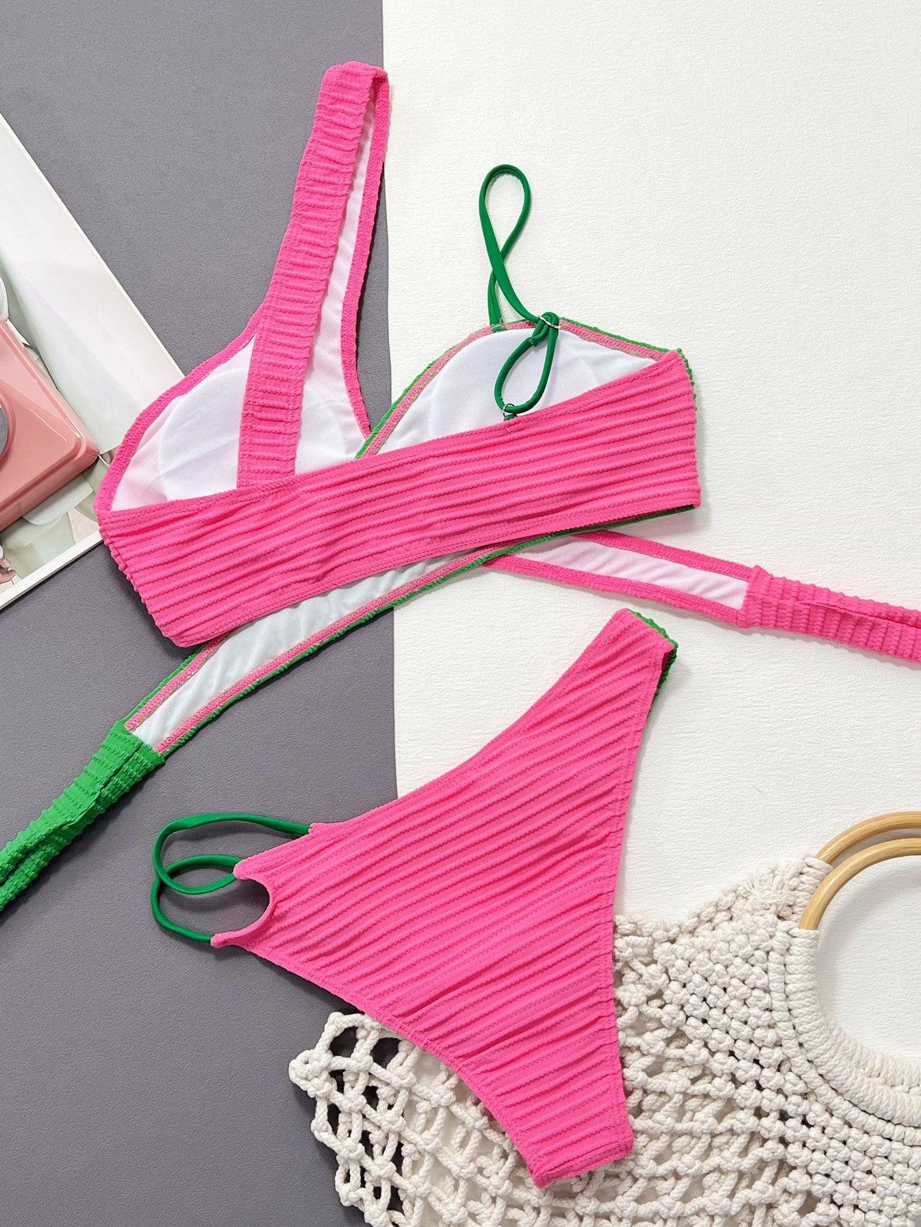 a pink bikini top with a green tassel