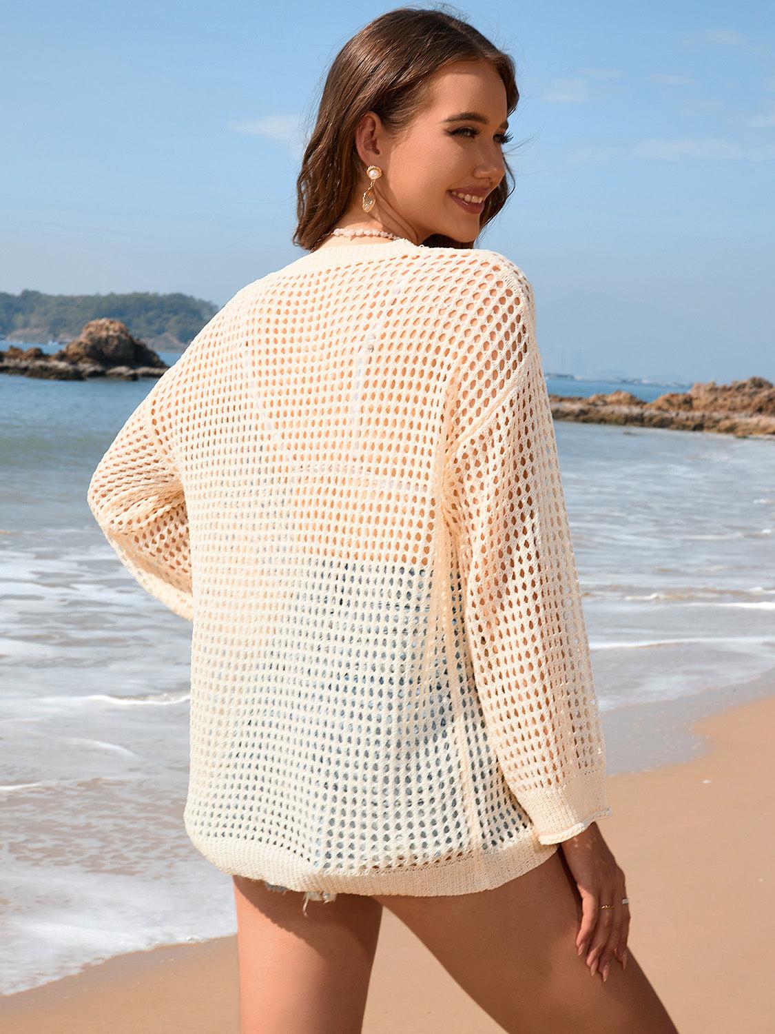 a woman standing on a beach next to the ocean