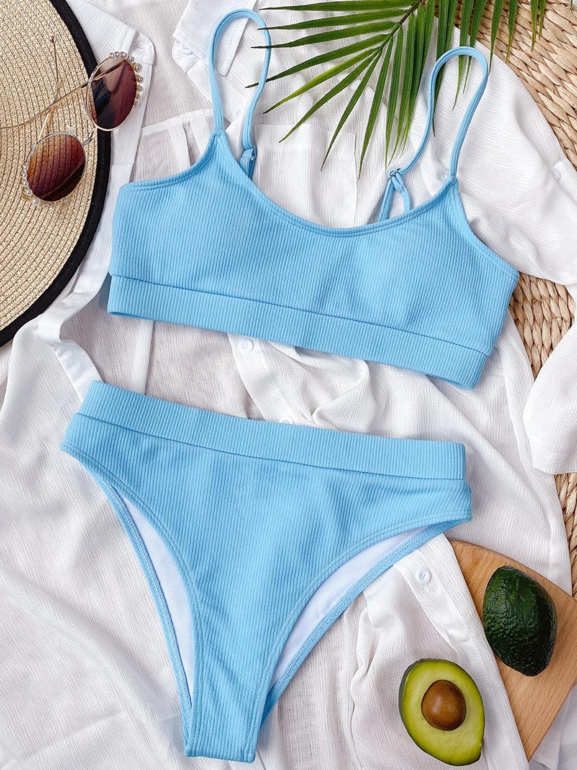 a woman's blue and white one piece swimsuit next to an avoca