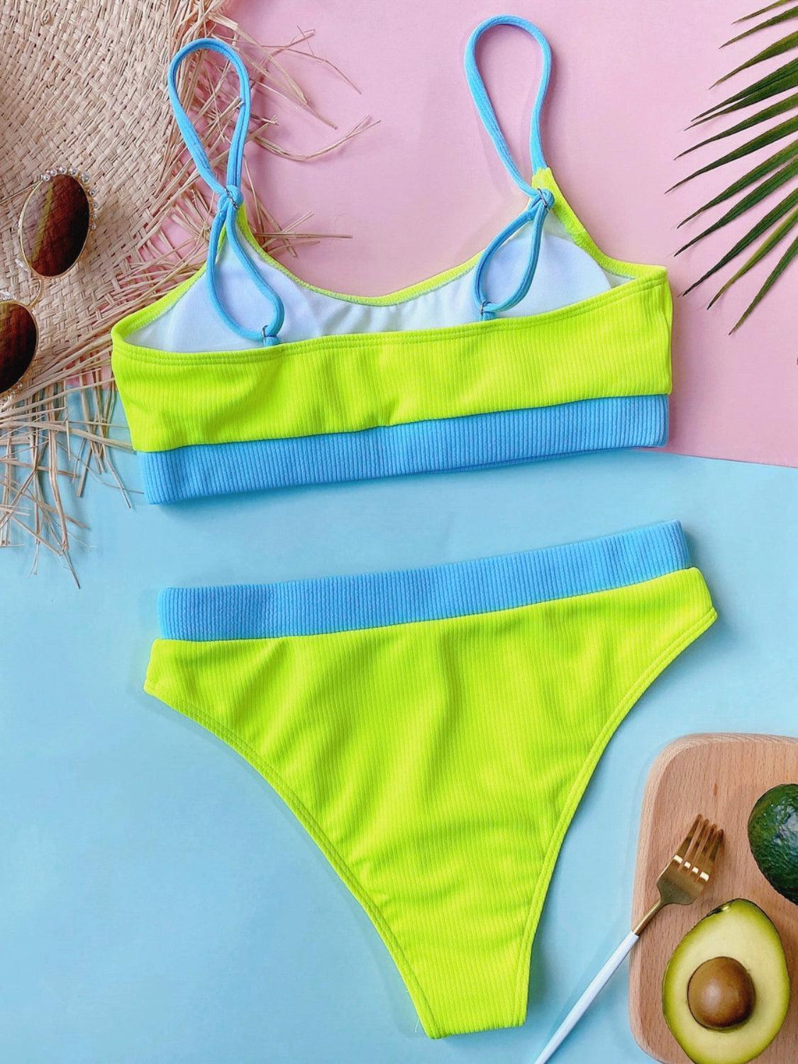 a yellow and blue one piece swimsuit next to an avocado