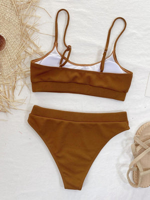 a bikini top and bottom with a pair of sandals