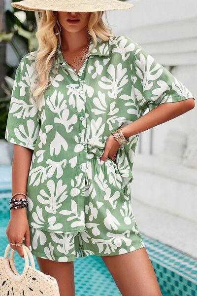 a woman wearing a green and white leaf print romper