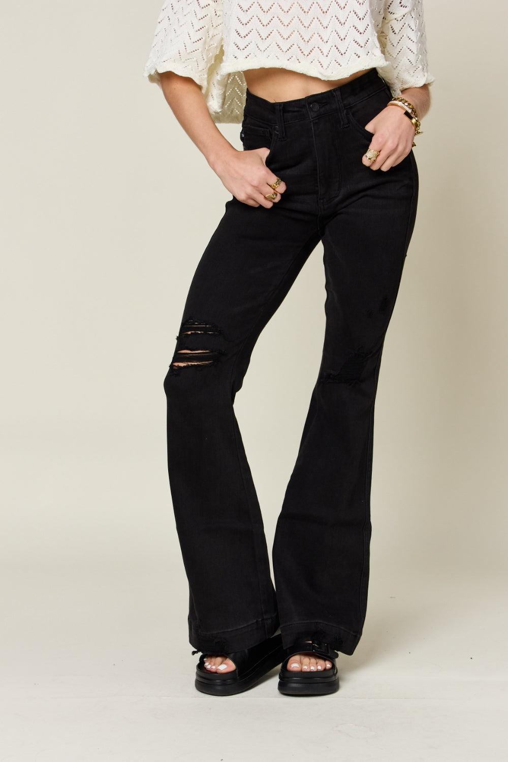 a woman wearing black jeans and a white top