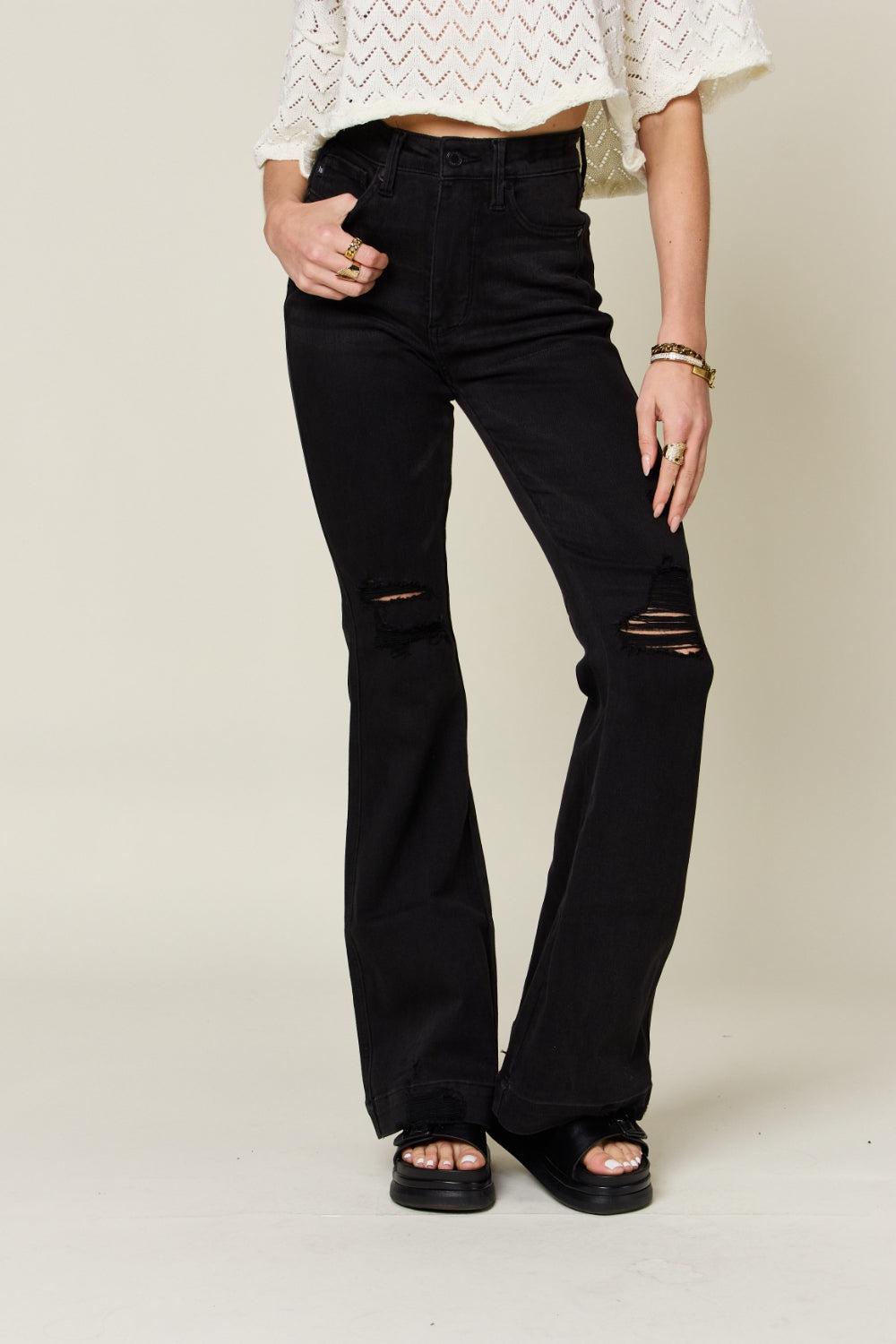 a woman wearing black jeans and a white top