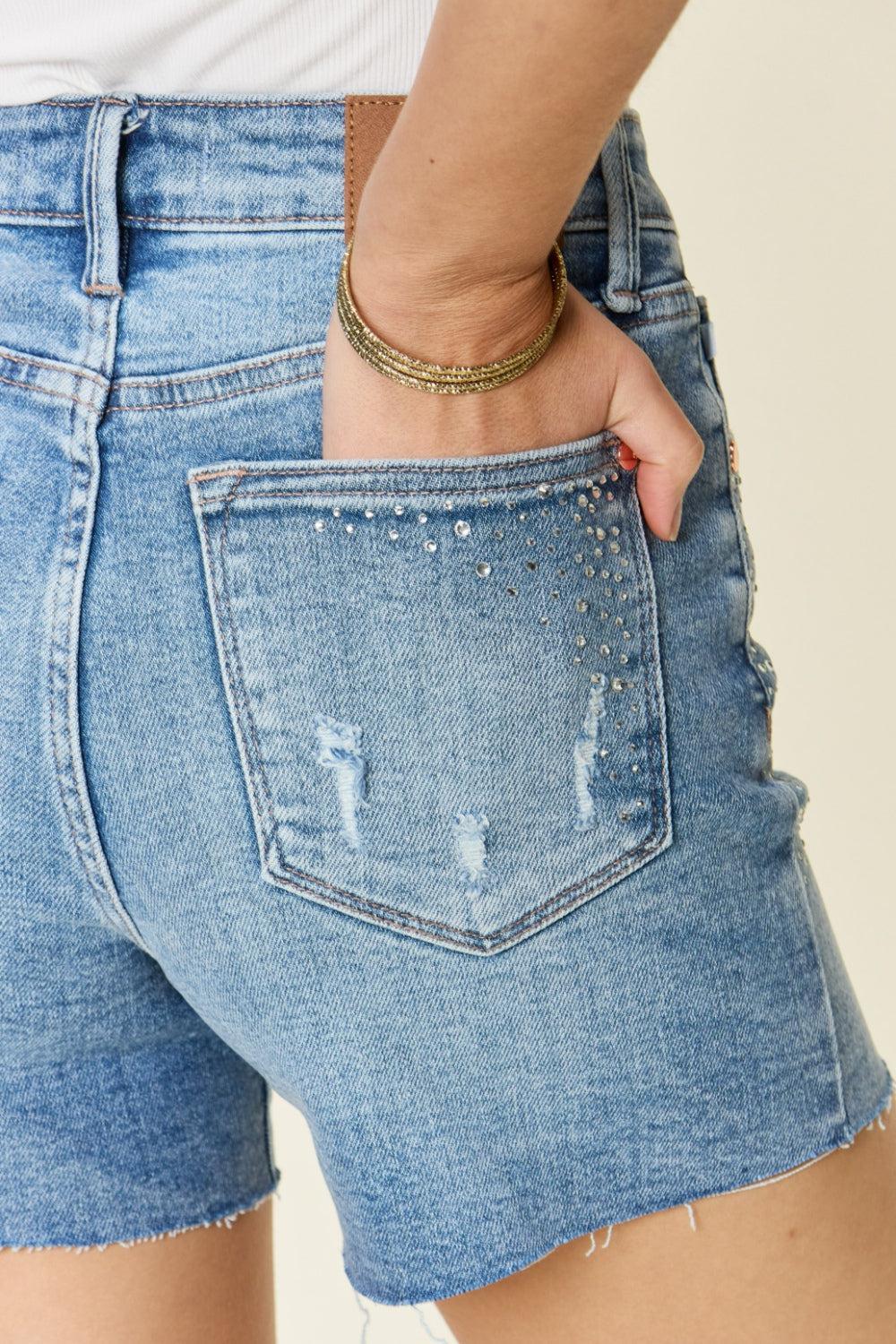 a woman is wearing a pair of shorts with holes in it