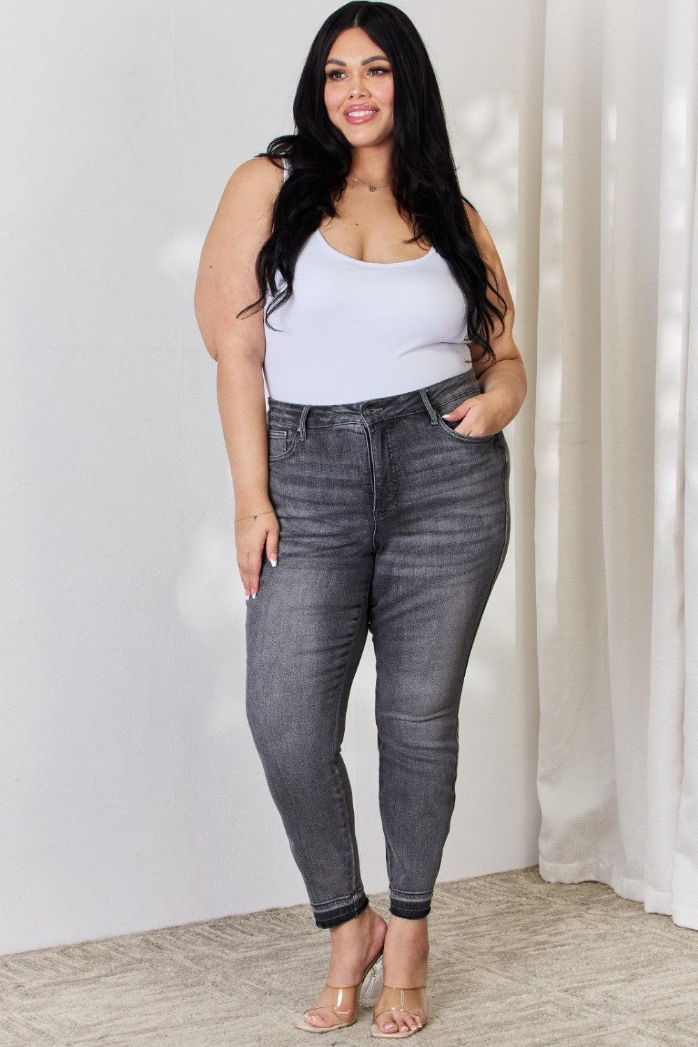 a woman standing in front of a white wall