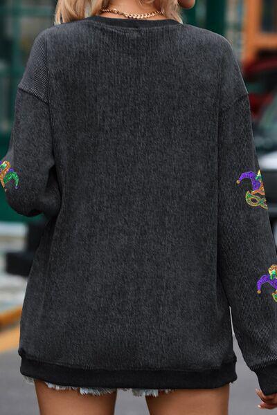 a woman walking down a street wearing a black sweater