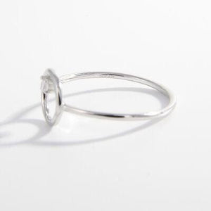 a white gold ring with a single diamond