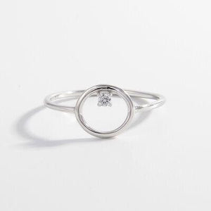 a white gold ring with a single diamond