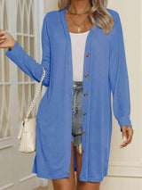 a woman wearing a blue cardigan sweater and shorts