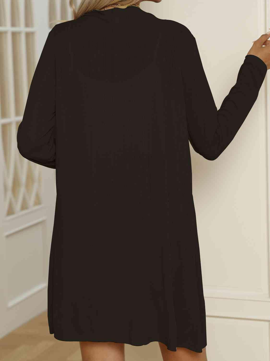 the back of a woman's black shirt dress