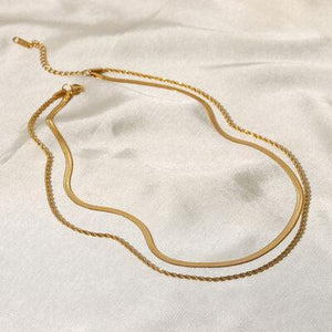 a close up of a necklace on a white sheet