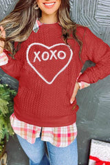 a woman wearing a red sweater with a heart on it