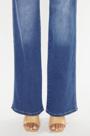 a pair of jeans with a woman's feet in them