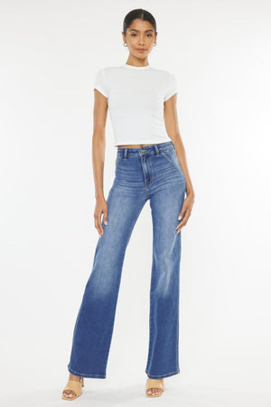 a woman in a white shirt and blue jeans